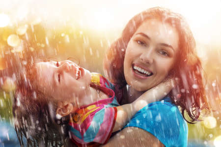 the family enjoys the rainの写真素材