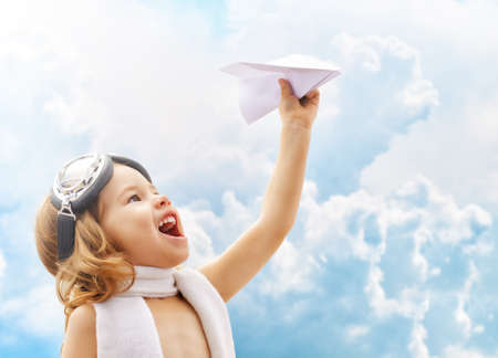 A child plays an airplane pilotの写真素材