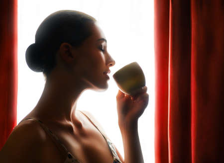 Woman with an aromatic coffee in handの写真素材