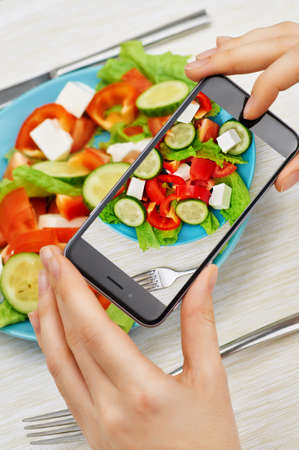 girl taking pictures of fresh saladの写真素材