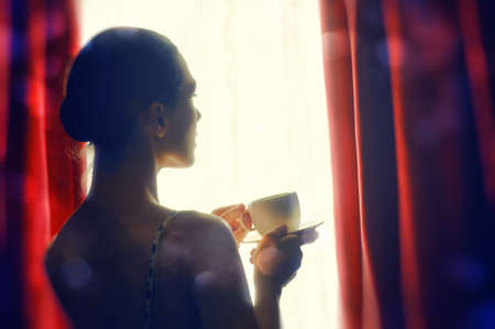 Woman with an aromatic coffee in handの写真素材