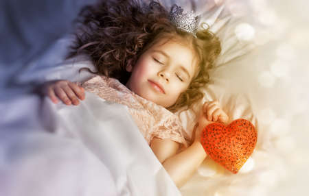 little girl sleeps in the bedroom