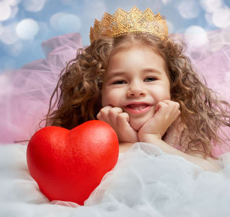 little girl holding a heartの写真素材