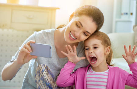 mother and daughter making a selfieの写真素材