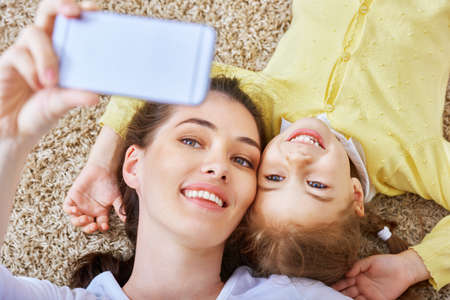 mother and daughter making a selfieの写真素材
