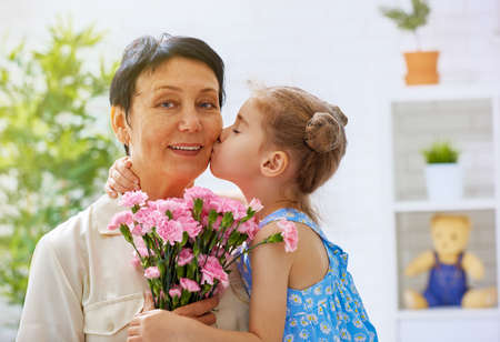 grandma and granddaughter with flowersの写真素材