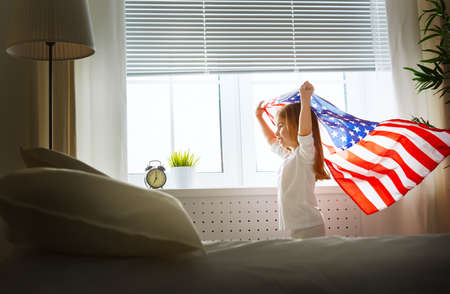 child holds a flag of Americaの写真素材