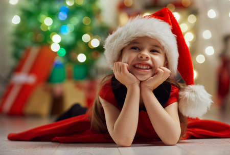 little cute girl with Christmas giftsの写真素材