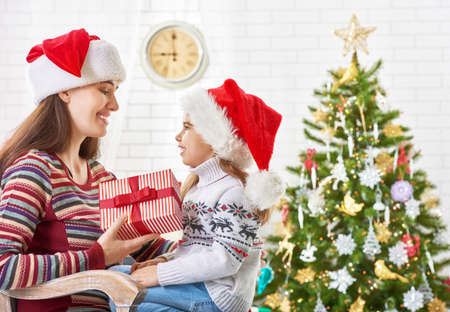 Mother and daughter exchanging Christmas giftsの写真素材
