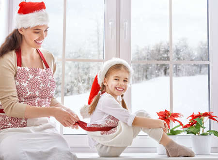Happy mother and daughter preparing for Christmasの写真素材