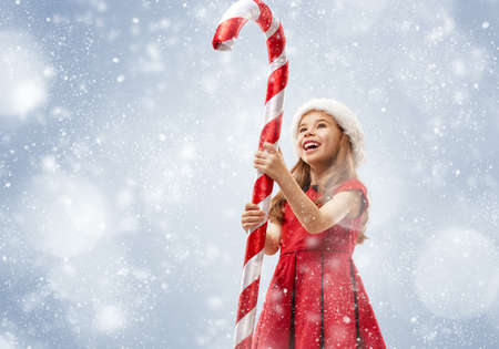 Christmas Eve! Happy child with a huge Christmas Lollipopの写真素材