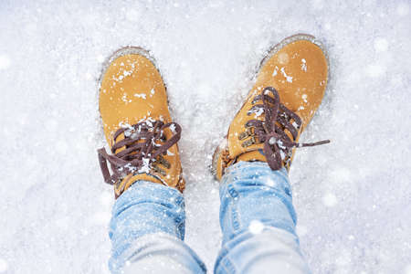 a walk in the snow. closeup of winter shoes.の写真素材