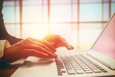 Business man working at office with laptop