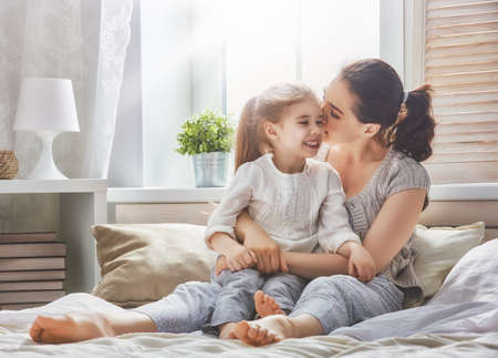 Happy loving family. Mother and her daughter child girl playing and hugging.の写真素材