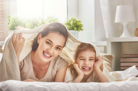 Happy loving family. Mother and her daughter child girl playing and hugging.の写真素材