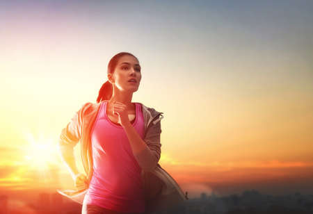 Athletic young woman running in the nature. Healthy lifestyle.の写真素材