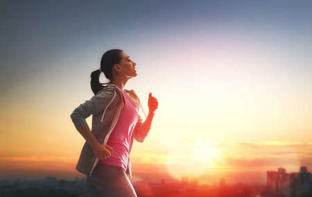 Athletic young woman running in the nature. Healthy lifestyle.の写真素材