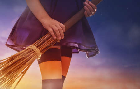 Happy Halloween! Little witch with a broomstick.の写真素材