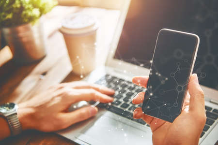 Man is using phone. Concept of young people are working with mobile devices, online shopping. Close...
