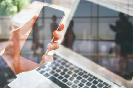 Man is using phone. Concept of young people are working with mobile devices, online shopping. Close up.の写真素材