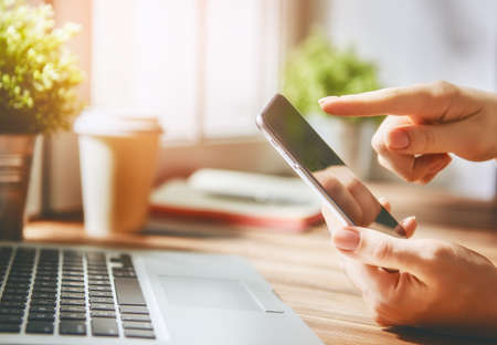 Woman is using phone. Concept of young people are working with mobile devices, online shopping....
