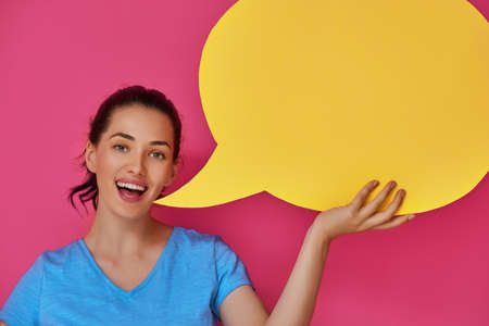 Beautiful young woman with cartoon speech on colorful background. Yellow, pink and blue colors.