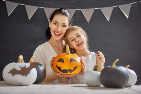 Mother and her daughter having fun at home. Happy Family preparing for Halloween.の写真素材