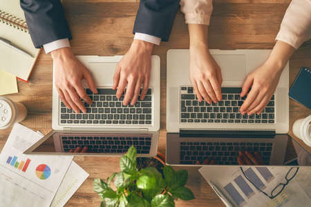 man and woman working on their computers. the view from the top.