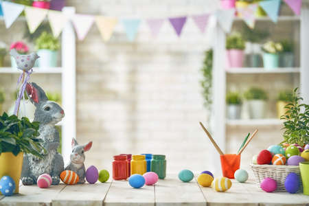 Happy Easter! Background with colorful eggs in basket. Table decorating for holiday.