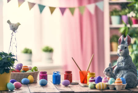 Happy Easter! Background with colorful eggs in basket. Table decorating for holiday.の写真素材