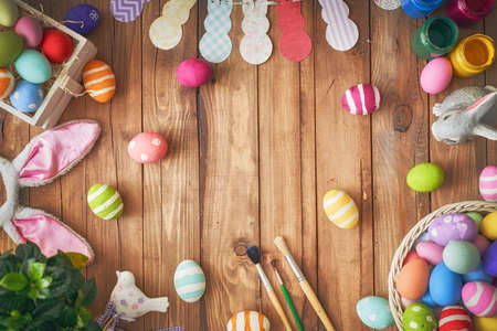 Happy Easter! Background with colorful eggs in basket. Table decorating for holiday. Top view.の写真素材