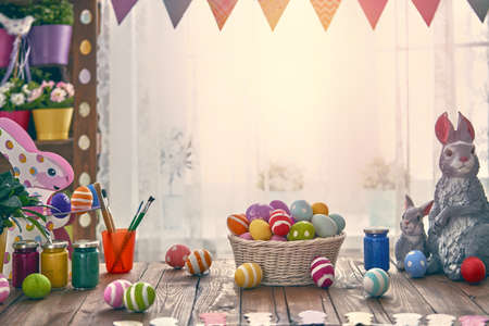 Happy Easter! Background with colorful eggs in basket. Table decorating for holiday.の写真素材