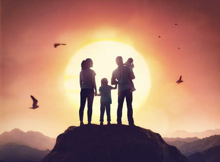 Happy family at sunset. Father, mother and two children daughters having fun and enjoying journey....