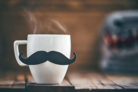 Happy father's day! Cup of coffee on background of wooden table.