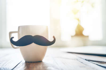 Happy father's day! Cup of coffee on background of wooden table.の写真素材