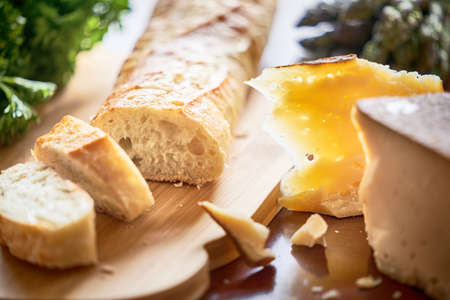Bread baguette and cheese on the table. Close up.