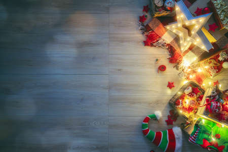 Merry Christmas and Happy Holidays! Baubles with ornaments on wooden desk. Top view. Xmas traditions. Space for your text.の写真素材