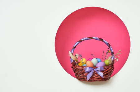 Happy Easter! Background with colorful eggs in basket. Space for your text.
