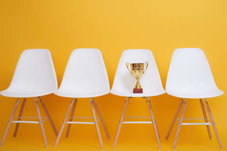 Golden Cup of winner on yellow background.の写真素材