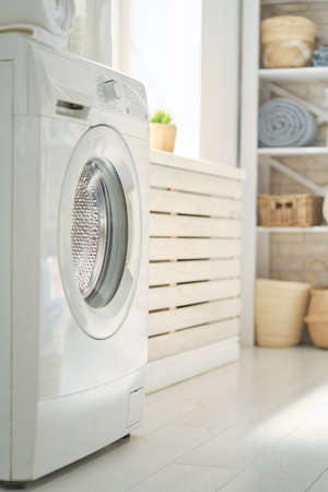 Interior of a real laundry room with a washing machine at homeの写真素材