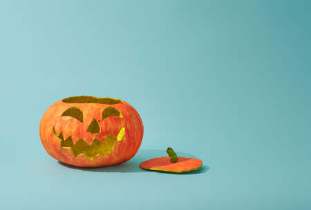 Happy halloween! Pumpkin lantern on turquoise