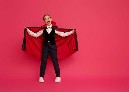 Happy Halloween! Cute little Dracula on pink background.