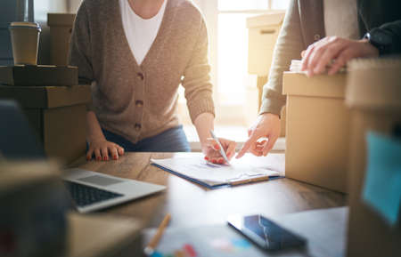 Two people are working together at warehouse for online seller.