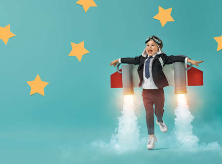 Little child in an astronaut costume is playing and dreaming of becoming a spaceman. Portrait of...