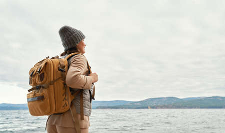 Happy young woman on a winter walk in nature.                               の写真素材