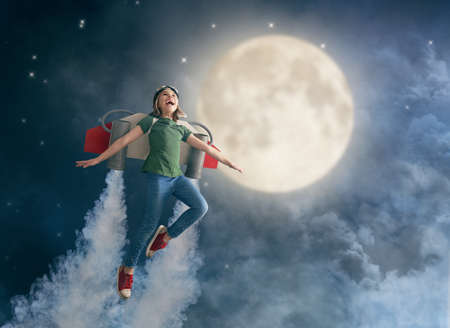Little child in an astronaut costume is playing and dreaming of becoming a spaceman. Portrait of...
