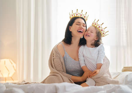 Happy loving family. Mother and her daughter child girl playing and hugging at home.の写真素材