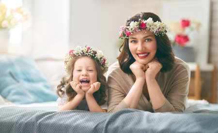 Happy mother's day! Child congratulating mom. Mum and daughter smiling and hugging. Family holiday and togetherness.の写真素材