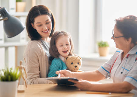 Child girl and her mother at a doctor's appointmentの写真素材