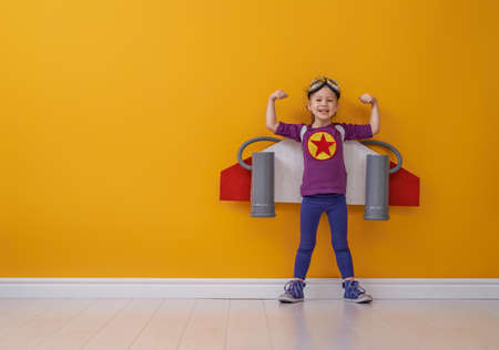 Little child girl in an astronaut costume is playing and dreaming of becoming a spaceman. Portrait...